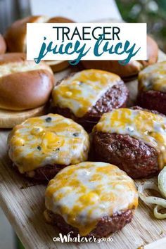 some hamburgers and onion rings on a wooden board with text overlay that reads tracer juicy lucky