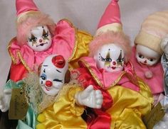 three clown dolls are sitting next to each other