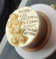 a cake with writing on it sitting on top of a plate