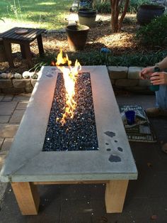 an outdoor fire pit with rocks and gravel