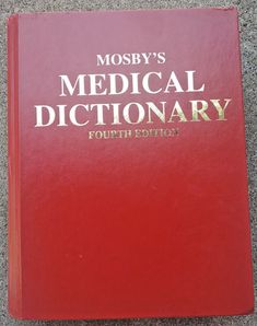 a red medical dictionary sitting on the ground