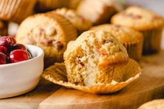 muffins with cranberries and a bowl of cherries on the side