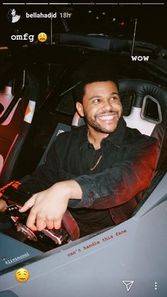 a man sitting in the driver's seat of a car smiling at the camera