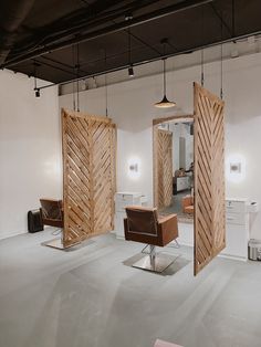 an open room with chairs and mirrors in it