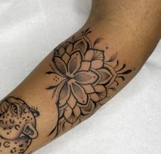 a tattoo on the arm of a man with a leopard and lotus flower in it