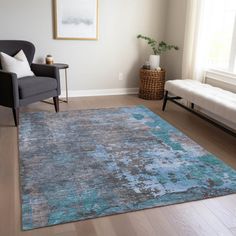 a living room with a couch, chair and rug