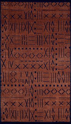 an area rug with black and brown designs on it's sides, including arrows