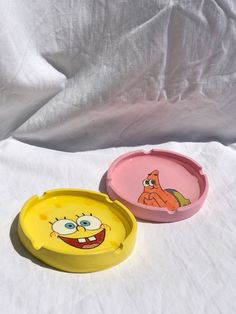 two cartoon plates sitting on top of a white sheet