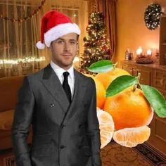 a man in a suit and santa hat standing next to an orange