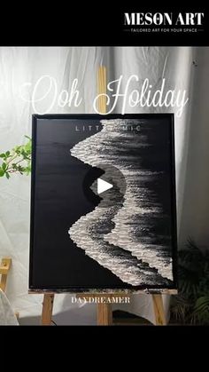 a black and white painting on an easel with the words oh holiday written in it