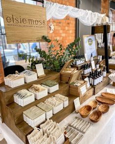 an assortment of soaps and body scrubs on display at a market stall for sale