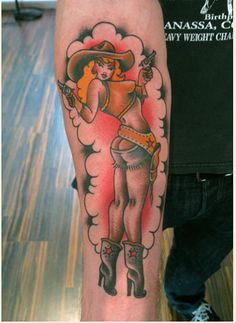 a person with a cowboy tattoo on their arm