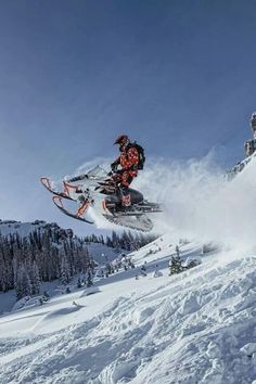 a man flying through the air while riding a snowmobile