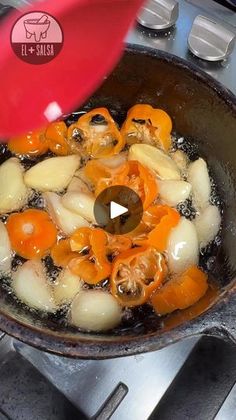 a frying pan filled with food on top of a stove