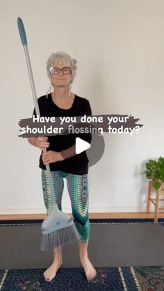 an older woman is holding a broom and wearing leggings with words that read have you done your shoulder flossing today?