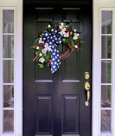 a patriotic wreath on the front door of a house