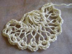 two pieces of crochet sitting on top of a table