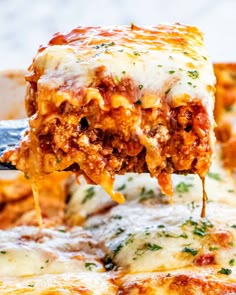 a slice of lasagna being lifted from a casserole dish with cheese