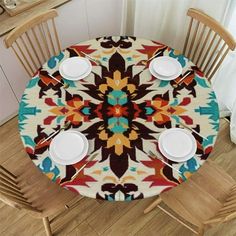 the table is set with four plates and two cups on it, along with three wooden chairs