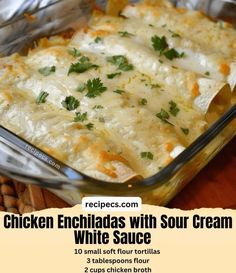 chicken enchiladas with sour cream and white sauce in a casserole dish