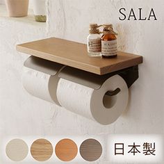 an advertisement for a bathroom with toilet paper on the wall and various items in front of it