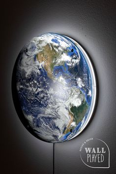 an image of the earth as seen from space on a wall mounted clock by walter played