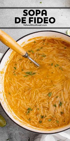 a large pot filled with pasta and garnished with parsley on the side