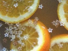 four oranges with white flowers on them are shown in close up view from above