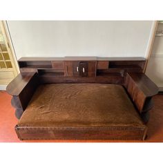 a wooden bed with two drawers on the top and bottom