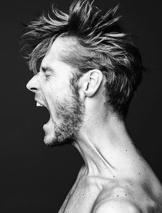 a shirtless man with his mouth open