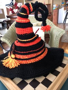 a crocheted witch hat sitting on top of a table