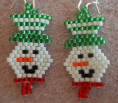 two snowmen made out of beads sitting next to each other