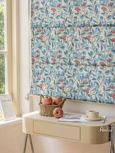 a table with some fruit on top of it next to a wall papered window