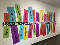 colorful bulletin board with love god, love people, make someone smile on the wall