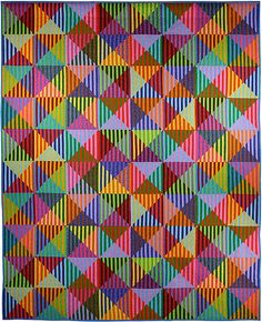 a multicolored quilt with many different shapes and sizes on the bottom, including triangles