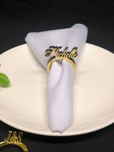 a white plate topped with a napkin and ring