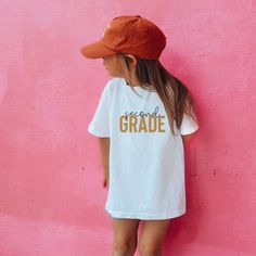 This tee is perfect for your kiddos to wear to school on any occasion! We are honored to make and design tee to fit your everyday needs. .: Made with 100%, midweight (5.3 oz/yd² (180 g/m US cotton that feels soft to the touch and a great choice for any season. .: All t-shirts come with tear-away labels for total comfort and a scratch-free experience. .: Fabric blends: Heather colors - 50% cotton, 50% polyester,  Sport Grey - 90% cotton, 10% polyester. -Processing 7-9 business days -Please make purchases with ample time Short Sleeve T-shirt For School Events In Summer, White School Spirit T-shirt For Everyday, Cotton School T-shirt With Slogan, Graphic Tee With Name Print For School, School Graphic Tee With Name Print, Back To School Spirit Cotton T-shirt, School Spirit T-shirt With Text Print For Everyday, Cotton T-shirt For Back To School With School Spirit, Casual T-shirt With Name Print For School Events