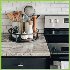 a kitchen counter with utensils and pots on it