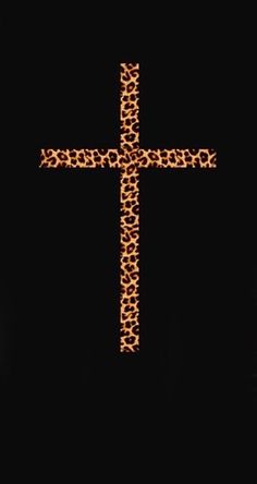 a cross made out of leopard print on a black background