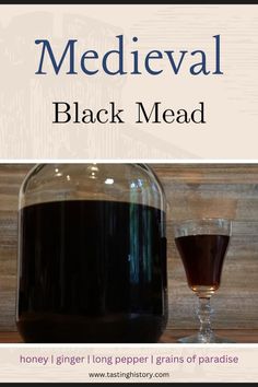 a bottle of black mead next to a glass filled with liquid