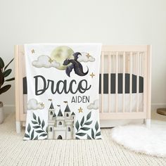 a baby crib with a blanket that says, drago aden