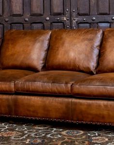 Experience the ultimate in comfort and western style with our Rambler Western Leather Sofa. This premium piece combines sophisticated looks and unparalleled comfort for a truly exceptional addition to any space. Intricate elements and the highest quality leather. This sofa is adorned in the most luxurious hand-burnished leather, which has been expertly aged in specific areas to showcase the effects that only time, use, and meticulous care can create. The intricate whip-stitched arms and studded Distressed Leather Sofa Tan, Luxury Leather Furniture, Western Recliner Sofa, Western Candle Holders, Western Chair, Western Candles, Pendleton Fabric, Brown Lesther Sofa, Leather Tuffed Couches