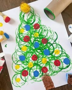 a child's drawing of a christmas tree made with colored crayons and toilet paper