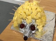 a cake made to look like a hedgehog with cheese on it's head