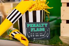 there is a sign that says penalty flags next to some yellow flowers and a blackboard