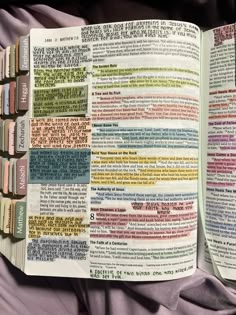 an open bible with many different colored pages