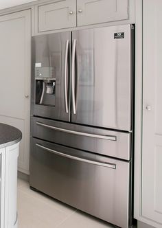 a stainless steel refrigerator and freezer combo in a kitchen