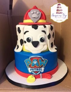 a birthday cake made to look like a fireman's hat and dalmatian dog