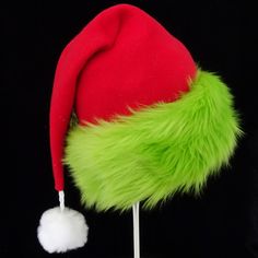 "This festive Santa hat is made up in a red fleece fabric and features an accent brim of lush bright green fur trim, close match to a Grinch green. The red fabric is a soft quality poly fleece fabric, cozy and warm. Proportions of the hat are generous and will fit most head sizes, ladies or gents. The styling is a slouch cone, traditional Santa look. Measurement for opening for your head is 24- 25\" circumference and the length is 20\". There is a white faux fur pompom dangle on the hat." Green Brimmed Winter Costume Hats, Green Winter Costume Hats And Headpieces, Grinch Hat, Kids Santa Hat, Christmas Party Hat, Funny Christmas Hats, Christmas Party Hats, Green Santa, Red Green Christmas