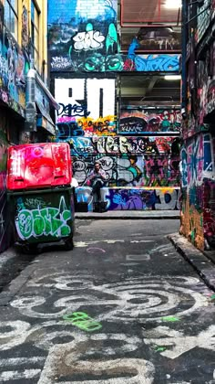 an alleyway with graffiti all over the walls and on the ground in front of it